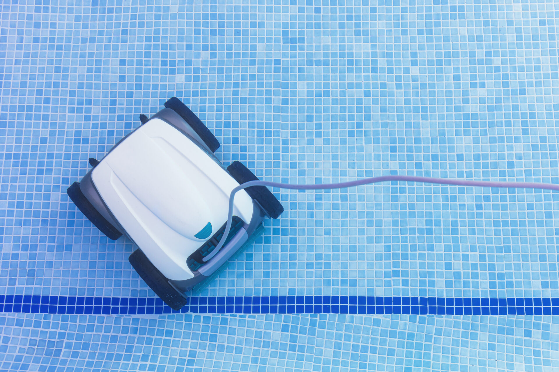 Underwater pool vacuum cleaner. Robotic cleaning of the pool floor. Pool cleaner robot Pool maintenance with automatic robot. Cleaning the bottom of the pool and walls with a submersible robot.